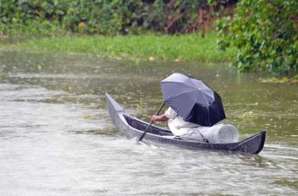 India, Kerala, Cochin, waterways rainswept canoe
